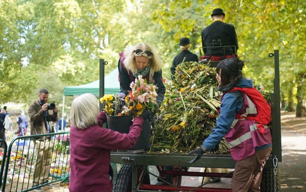 El personal de los Parques Reales y los voluntarios retiran las ofrendas florales de Green Park